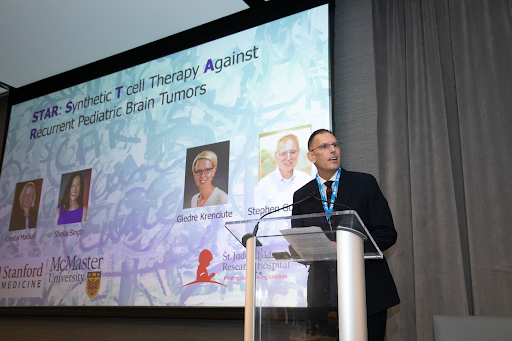 Speaker at a podium at the ACGT Summit